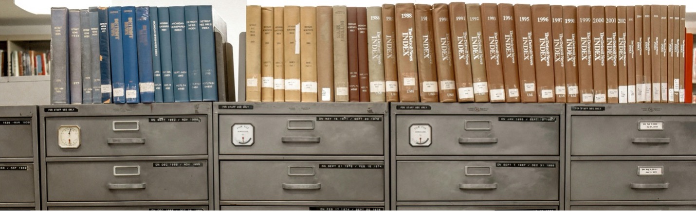 Series of report books lined up on top of old filing cabinets circa 1950s